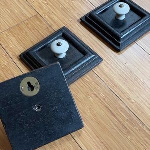3 piece set of wall hook.  Porcelain knobs on 4x4 dark brown wood squares.